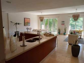 Bright living and dining area with marble floors and ocean view balcony in Buenaventura Panama