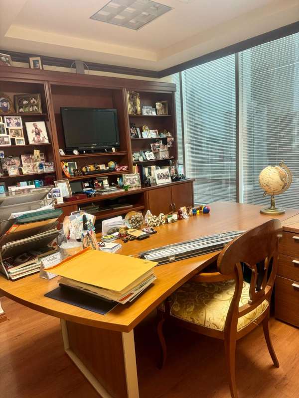 Furnished traditional office interior with wooden furniture, TV, window blinds at BICSA Tower Panama