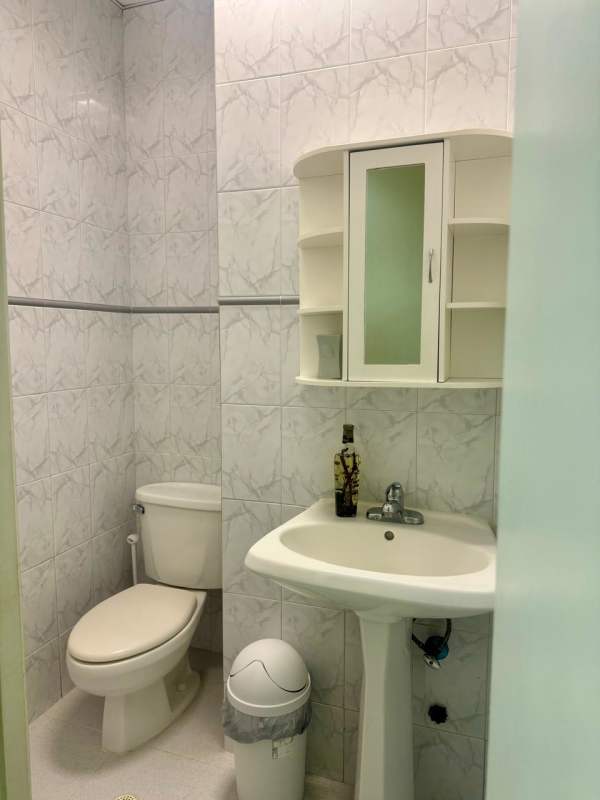 Small bathroom with marble tiles, sink, mirror cabinet in PH BICSA Tower Panama