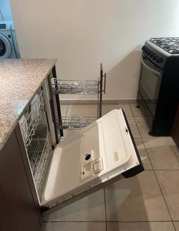 Open kitchen with dark granite counters, tile floors, gas stove, dishwasher PH Panama City