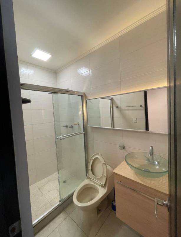 Bathroom with glass shower, mirror, vessel sink and modern finishes Panama City