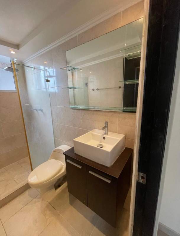 Open living and dining area with balcony access, ceiling fan, tile flooring in Panama City rental