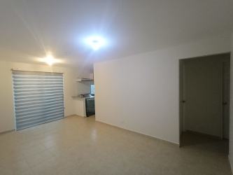 Bright minimalist living room with tiled floor and ceiling light in Puerto Caimito house