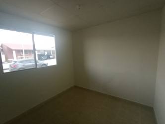 Side exterior with fenced yard and sliding door in Puerto Caimito house