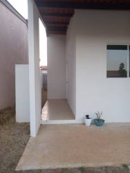 Exterior of single-family affordable home with driveway and covered porch in La Chorrera