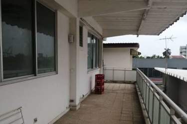 Outdoor balcony with metal security grills overlooking Colon Free Zone Panama