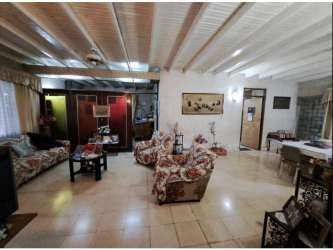 Spacious layout with exposed beams, window light and dining table in Carrasquilla Panama
