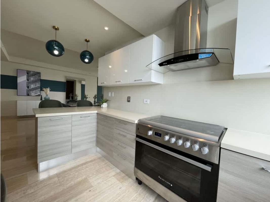 New kitchen featuring stainless appliances, island and open view to dining area PH The Regent Panama