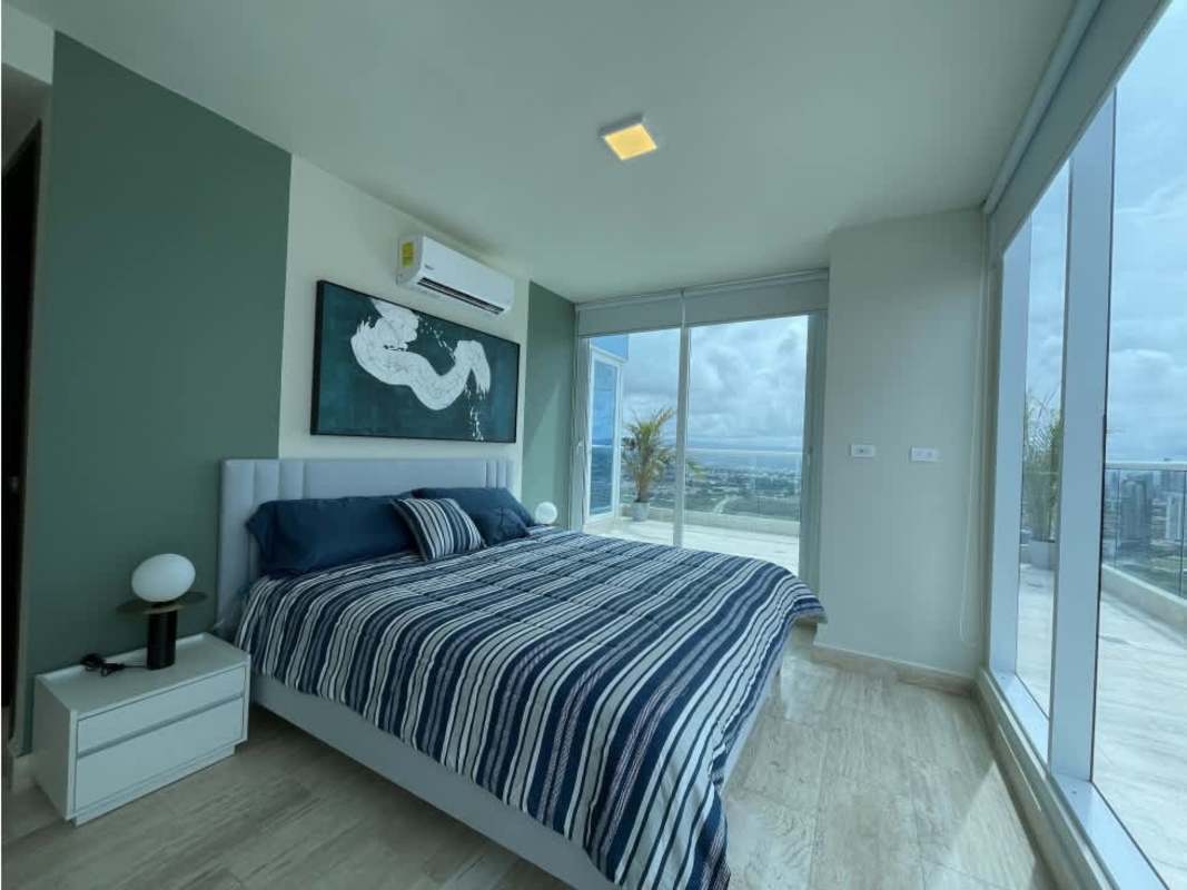 Modern bedroom with skyline views through floor-to-ceiling glass PH The Regent Costa del Este