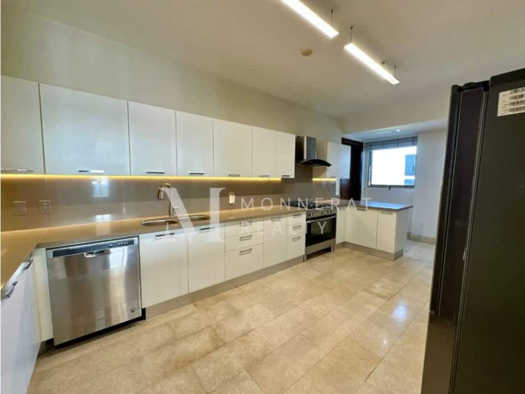 Modern kitchen with white cabinetry, island, stainless steel appliances in Greenview Residences Santa María