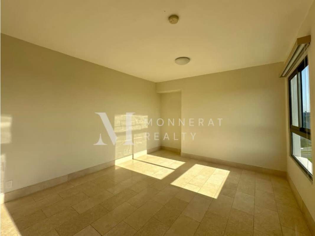 Luxury master bedroom suite with large windows overlooking golf course in Santa María Panama