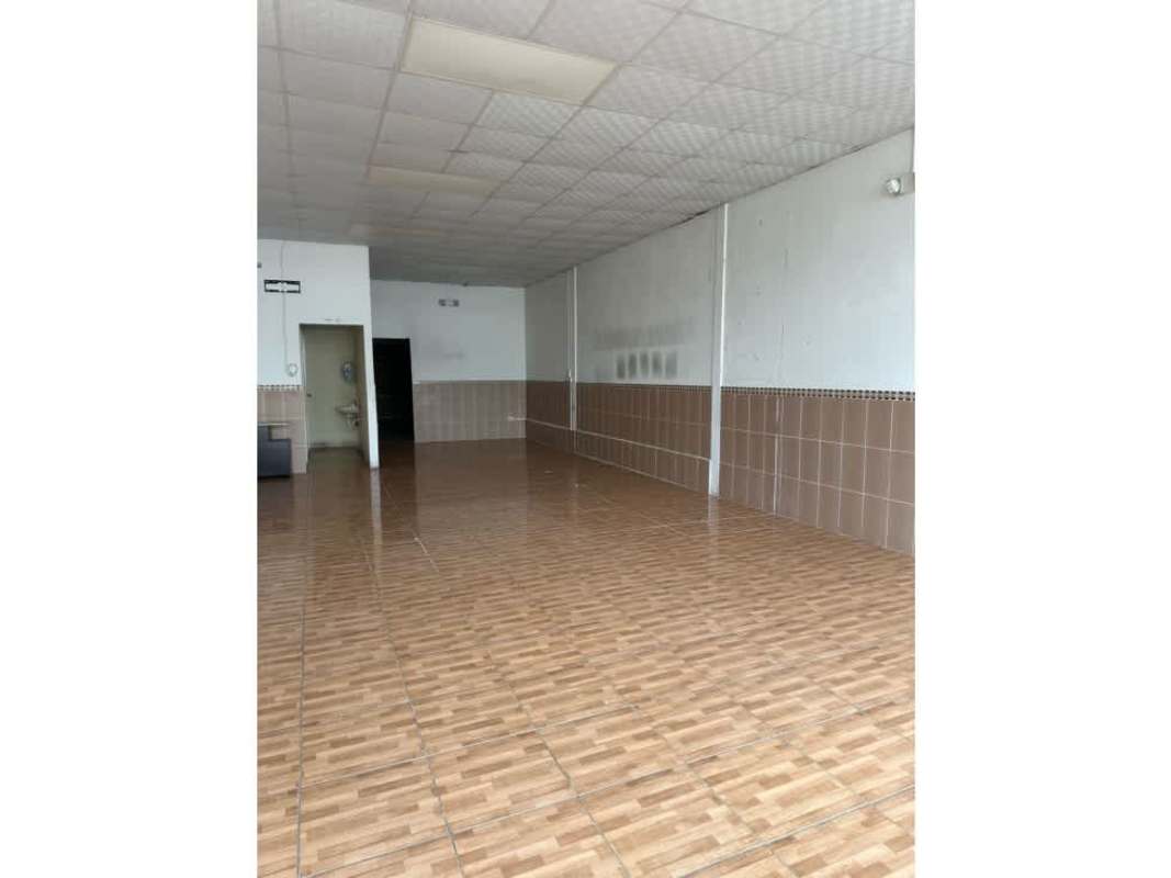 Commercial interior showing wall tiles, utility sink area with unfinished construction features
