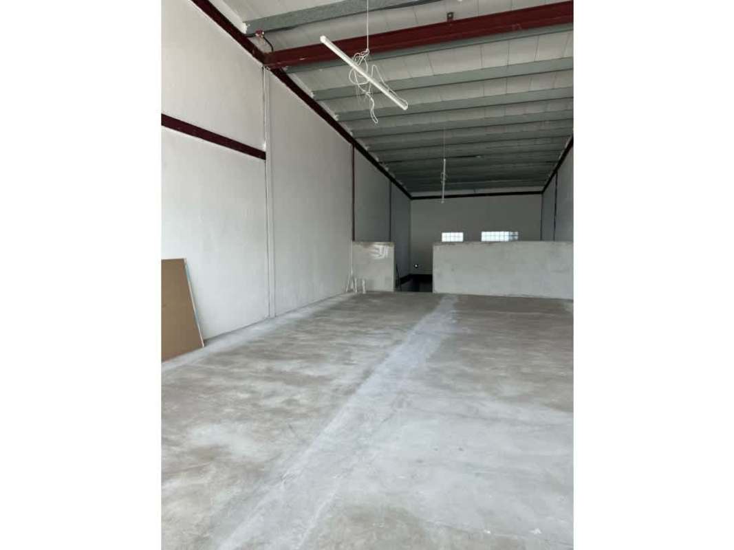Warehouse with concrete floors, loading access, high ceilings, and front windows