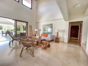 Double-height living room with vaulted ceiling, large windows, terrace access at Buenaventura Villa Panama