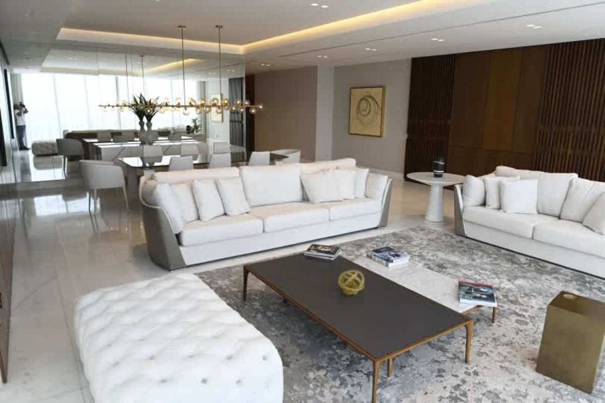 Spacious living and dining area with marble floors and large windows overlooking ocean in PH Ocean Waves Punta Pacífica