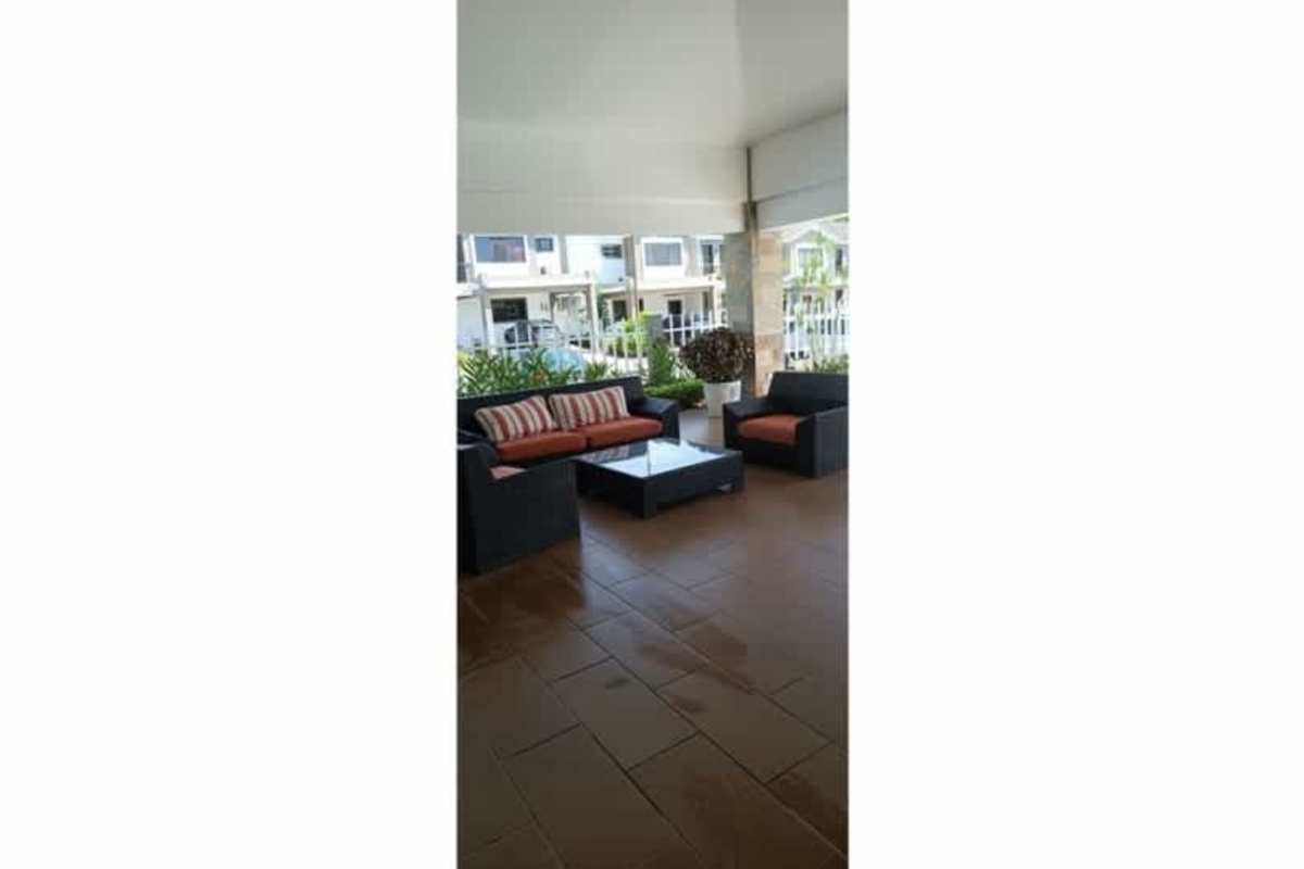 Covered outdoor lounge area with sofa set and coffee table Paseo del Norte Panama