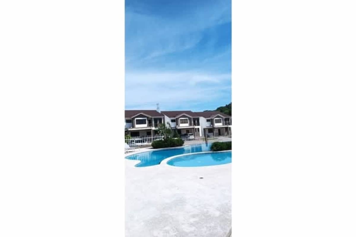 Community swimming pools with garden and lounge spaces at Paseo del Norte Panama