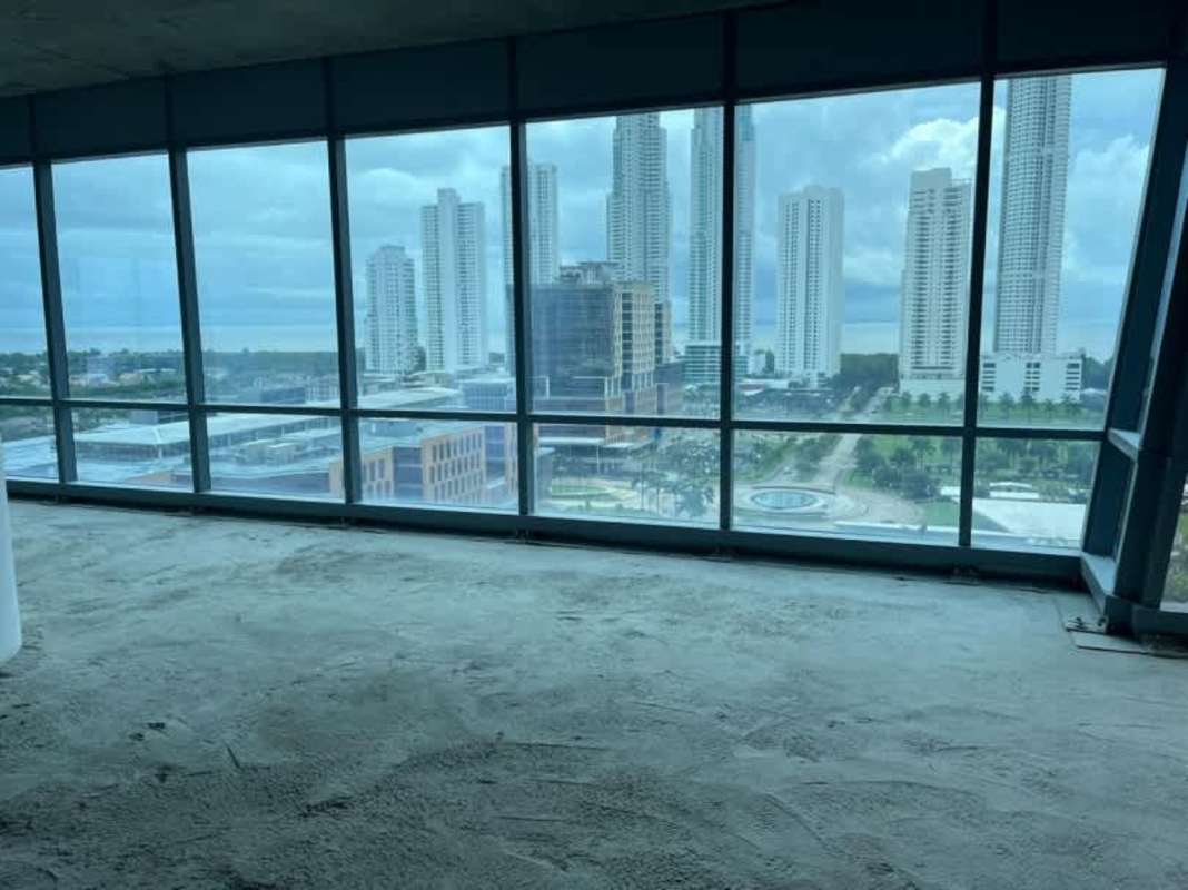 Interior unfinished office space with floor-to-ceiling glass and ocean-city views in Times Square Center Panama