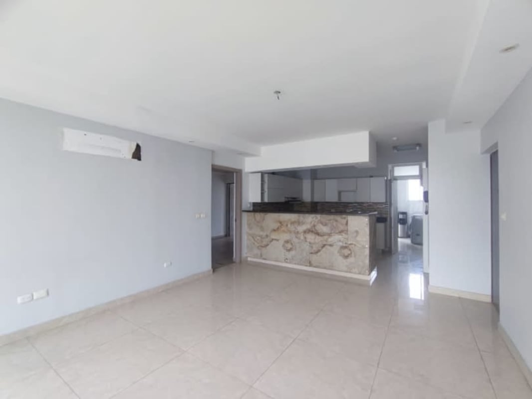 Spacious living and dining area opening onto balcony with skyline views in PH Bayside Tower Panama City