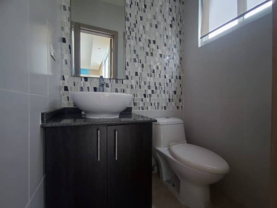 Elegant bathroom with granite countertop, vessel sink, mosaic tile accents in PH Bayside Tower Panama