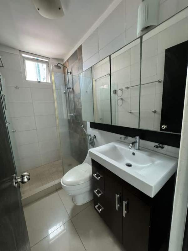 Bathroom with glass shower enclosure, modern vanity, tile walls at PH Mirador Bella Vista Panama