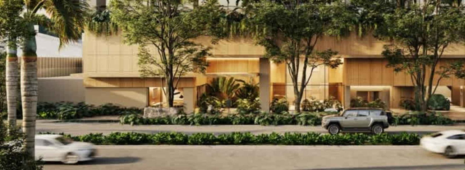 Contemporary luxury condo tower entrance with lush greenery in Costa del Este Panama City