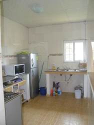 Functional kitchen with appliances window tile floor rural home Barrio Colón Panama