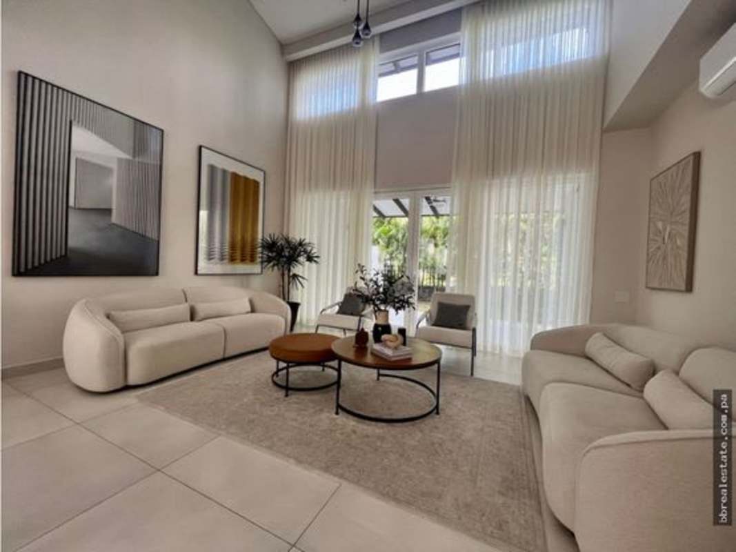 Spacious living room with large floor-to-ceiling windows, cream sofas in The Woods Santa Maria