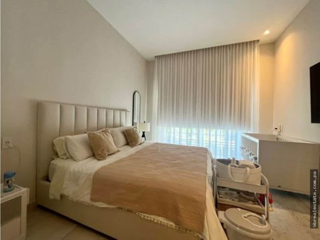 Contemporary dining area with round table large windows in luxury house The Woods Panama