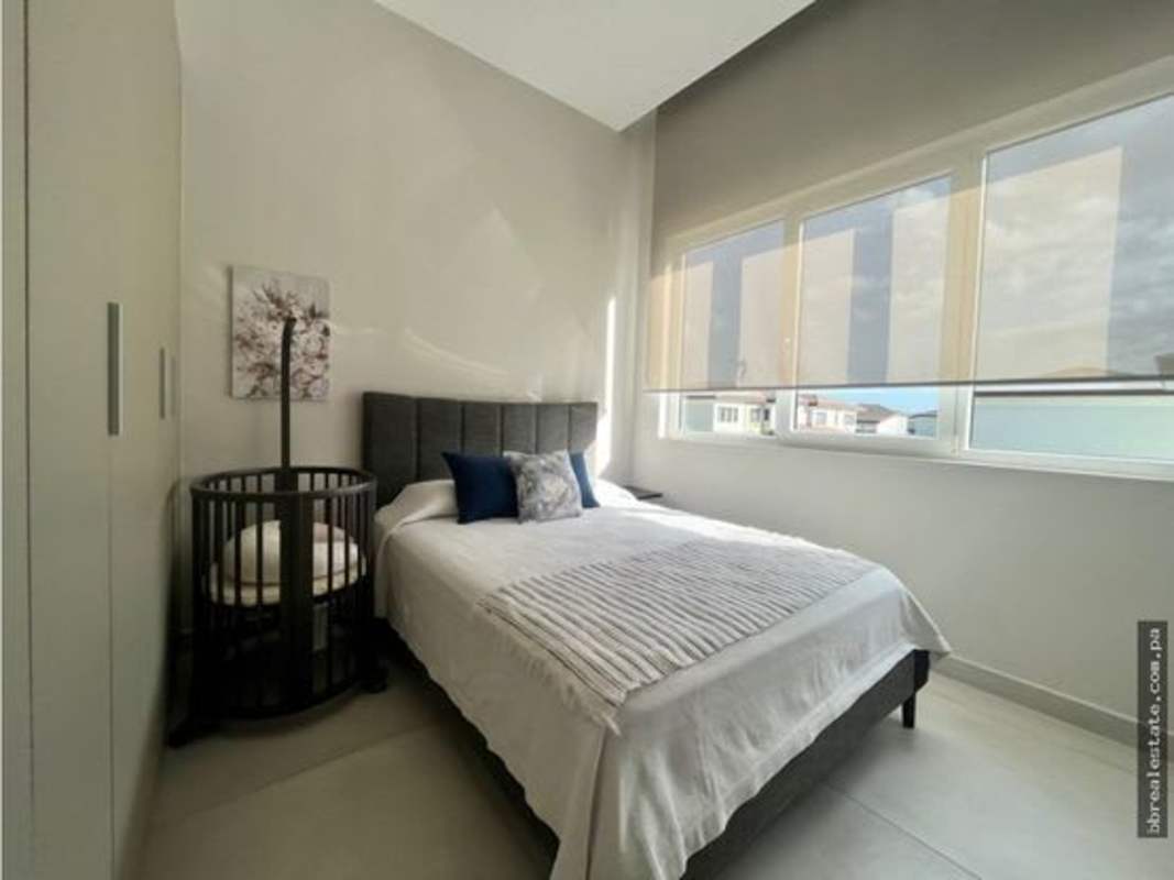Modern bedroom with windows, natural light, neutral tones at The Woods Santa Maria