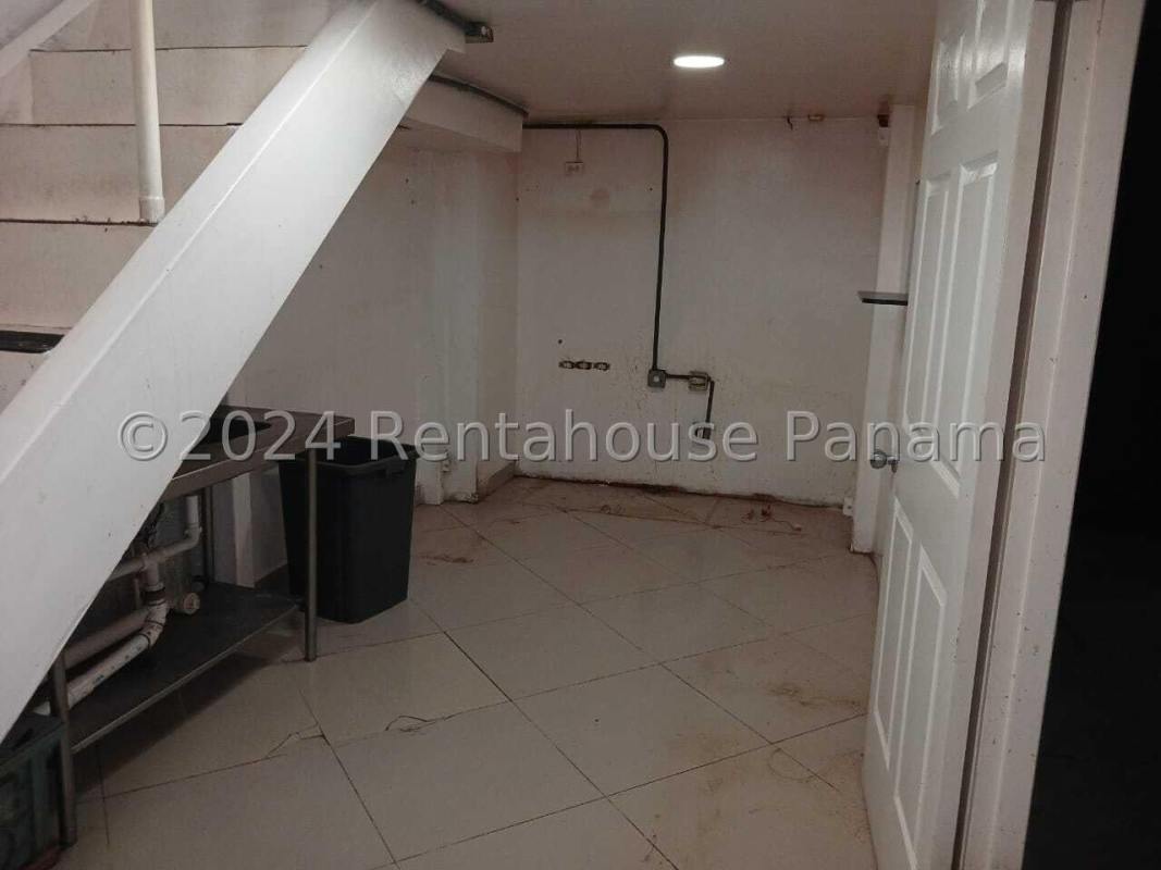 Spacious empty shopping mall retail interior with tile floors and branding wall