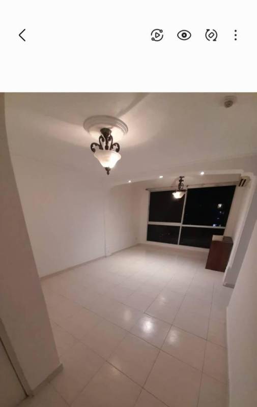 Large empty living room with white tile and window in PH McGregor Hill Condado del Rey Panama