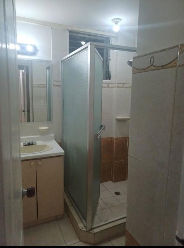 Spacious bedroom with wardrobe, tile floor, window at PH McGregor Hill Condado del Rey Panama