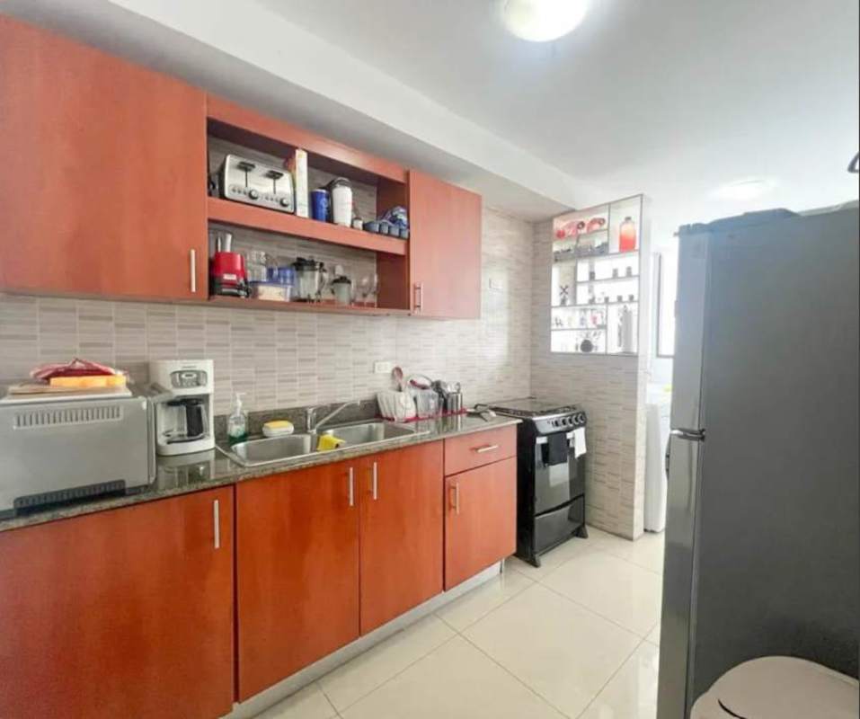 Modern kitchen with granite countertop, wooden cabinets, appliances-ready layout in San Francisco Bay Tower 500