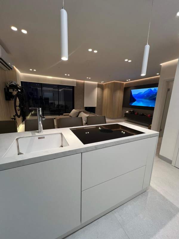 Open living, dining, kitchen area with floor-to-ceiling windows in PH Victory Wellness Coco del Mar