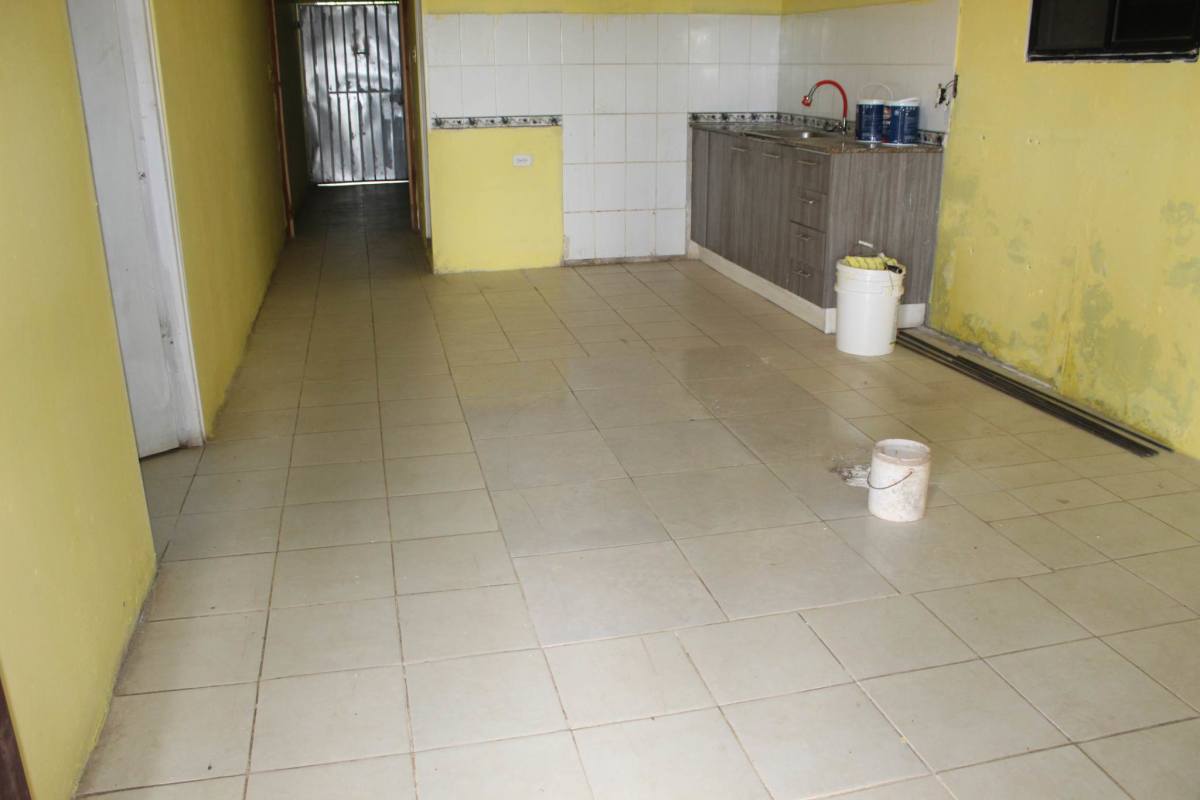 Basic kitchen interior yellow walls grey cabinets ceramic tile floor in Rana de Oro Pedregal Panama