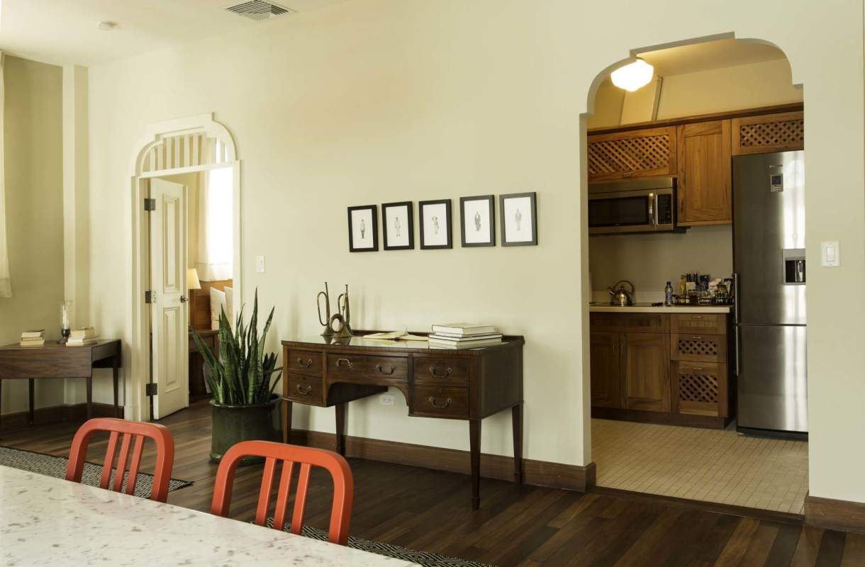 Dining space leading into wood cabinetry kitchen at Las Clementinas Casco Viejo Panama