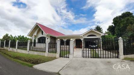 Exterior of house with gated entry red roof stone accents driveway La Mata Bugaba Chiriquí Panama