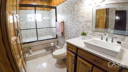 Rustic modern bathroom ceramic tile vanity wood cabinetry shower bathtub Bugaba Panama