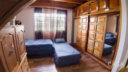 Bedroom with wood ceiling large window mirrored closet rustic design Bugaba Chiriquí Panama
