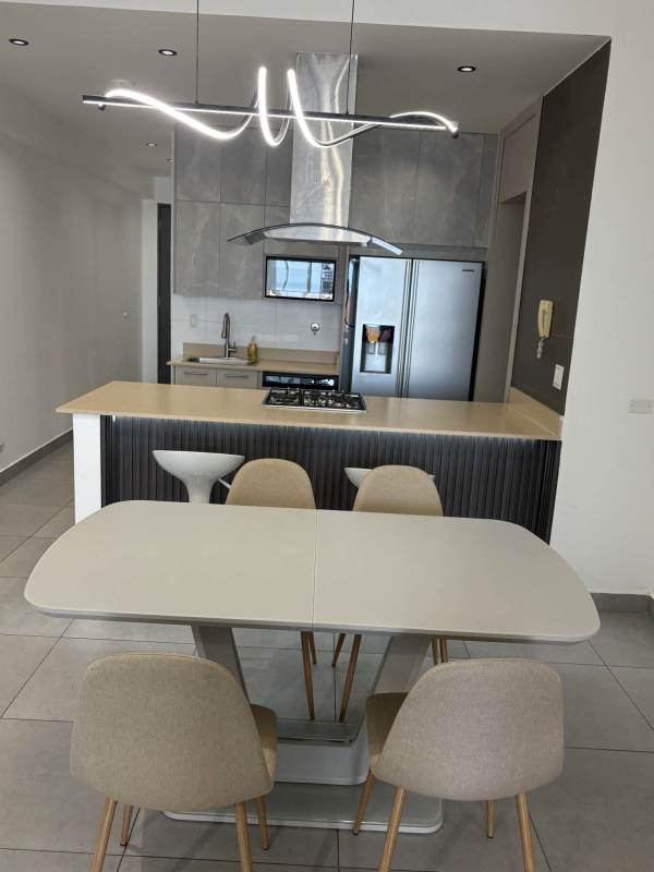 Contemporary kitchen with stainless steel appliances and island dining area in PH Element Avenida Balboa Panama