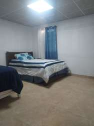 Bedroom with two beds, tiled flooring, simple design in house for sale La Villa de Los Santos Panama