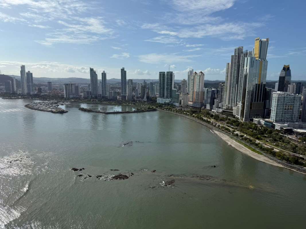 Spacious marble-floored living and dining room with floor to ceiling windows ocean view Punta Paitilla Panama