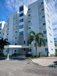 Modern beachfront condominium building PH Coral Park with balconies and palms in Río Hato Panama