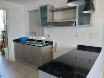 Modern kitchen with granite countertop, overhead cabinets and appliances in PH Coral Park Río Hato Panama