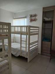 Kids room with bunk beds and built-in wardrobe in PH Coral Park Río Hato beach apartment