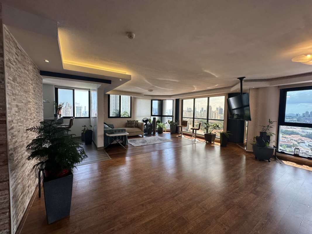 Bright open plan living and dining room with large windows and city view PH Sky View