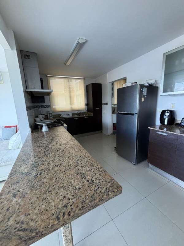 Modern kitchen granite countertop stainless appliances dark cabinetry in Albrook Condo Clayton Panama