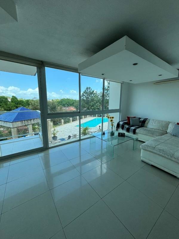 Minimalist bedroom with large windows, natural light and garden view at Clayton Park Residences Panama City