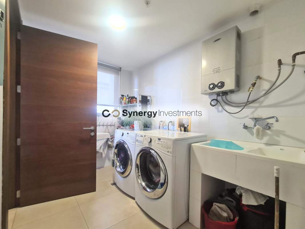 Open kitchen with marble counters and island, premium appliances in Santa Maria luxury condo Panama